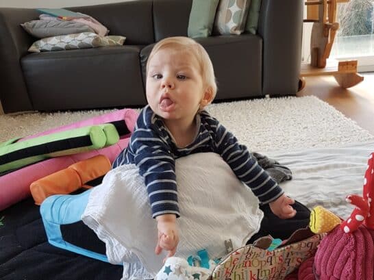 a baby lying on a blanket
