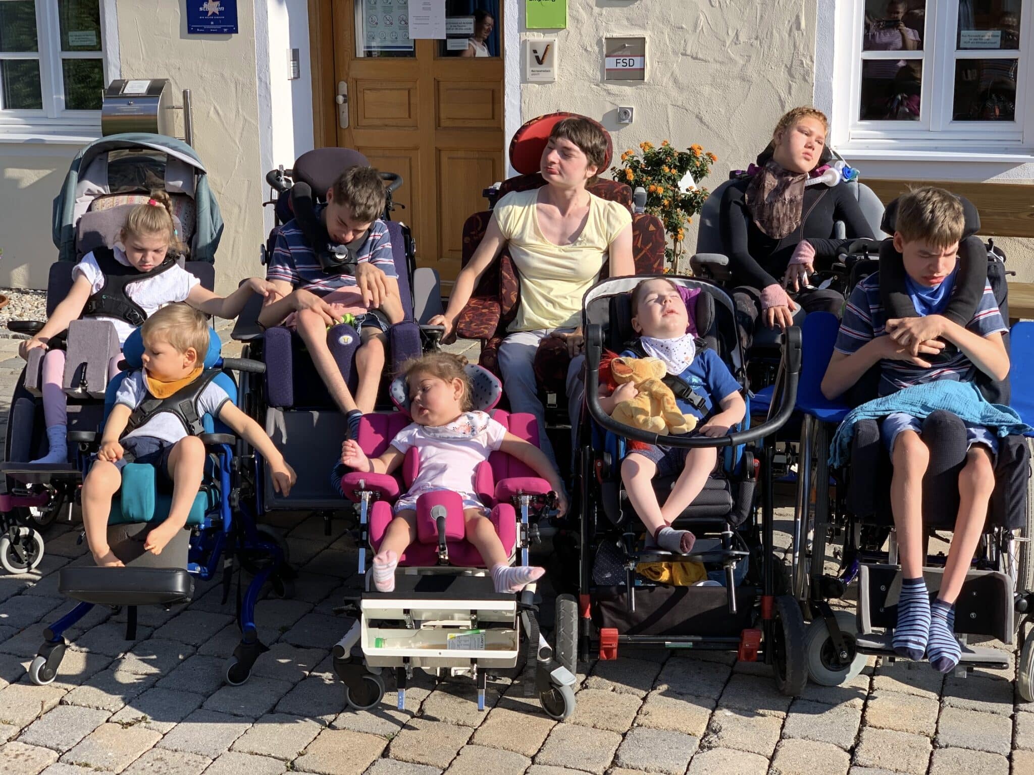 a group of people sitting in wheelchairs outside