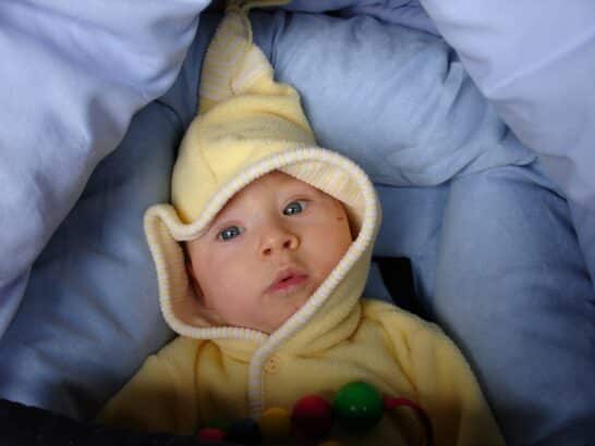 a baby in a yellow hoodie
