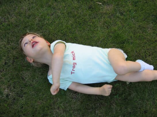 a child lying on grass