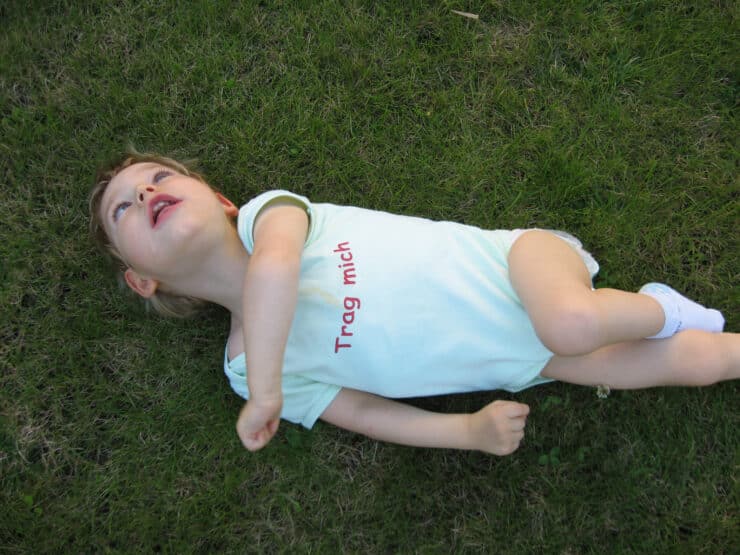 a child lying on grass